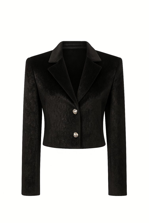 The Aurevia Wool Cropped Blazer redefines classic tailoring with a contemporary cropped silhouette and a refined wool texture. Designed for modern wardrobes, this statement blazer combines sharp tailoring with a soft, luxurious finish, creating a sophisticated balance between structure and elegance. Crafted with a premium wool blend fabric, Aurevia offers a rich texture and a warm, elevated feel while maintaining a clean and polished appearance. The strong shoulder structure, sharp lapels and minimalist two-button closure create a powerful yet feminine silhouette that complements both formal and elevated casual styling. The cropped length adds a modern touch to traditional tailoring, making this blazer an effortless choice for pairing with high-waisted trousers, skirts or dresses. Its deep black tone enhances its timeless character, allowing it to become a versatile wardrobe essential for refined occasions. Designed for women who appreciate understated luxury, the Aurevia Wool Cropped Blazer brings together craftsmanship, sophistication and contemporary fashion sensibility. Key Features Premium wool blend fabric with a soft textured finish Cropped tailored silhouette Structured shoulders for a refined shape Classic sharp lapel design Minimalist two-button front closure Long sleeves with clean finishing Elegant black color for versatile styling Suitable for both formal and elevated everyday looks