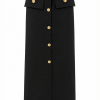 Auréline Skirt features structured pleats, elegant gold-button details, and a refined mini silhouette designed for sophisticated contemporary styling.