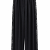 Premium black lace-panel trousers designed for sophisticated evening styling