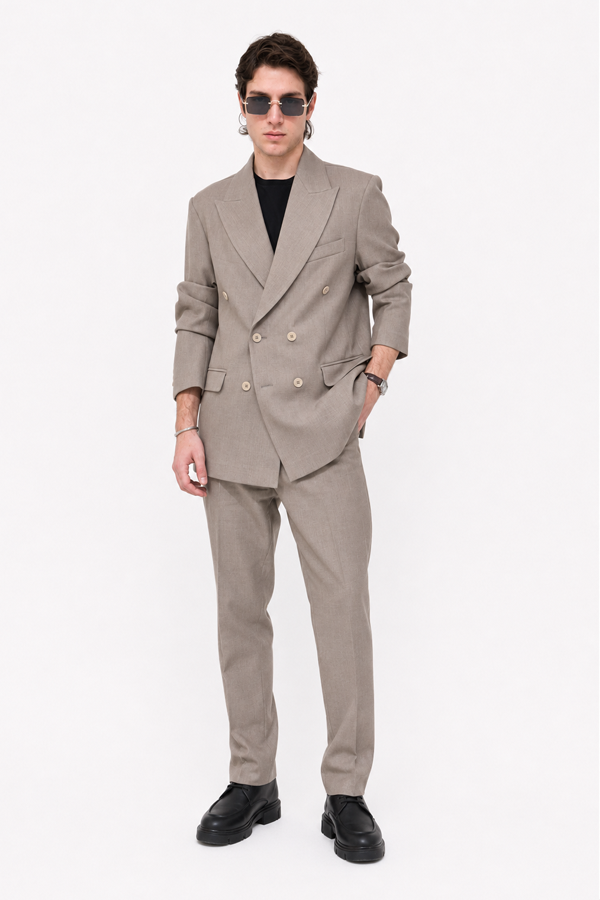 Male model wearing the Alaric Double-Breasted Suit with black sunglasses and leather shoes