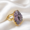 Gold Druzy Statement Ring displayed on white satin