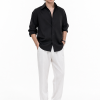 Leander Textured Black Shirt styled with white tailored trousers