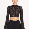 Luxury black floral lace crop top with high neckline and flared sleeves.