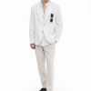 A lightweight white Patch-Pocket Linen Blazer featuring a two-button front, classic notch lapels, rounded patch pockets and a softly curved hem. The Marcell Linen Blazer combines breathable summer comfort with relaxed, contemporary tailoring.