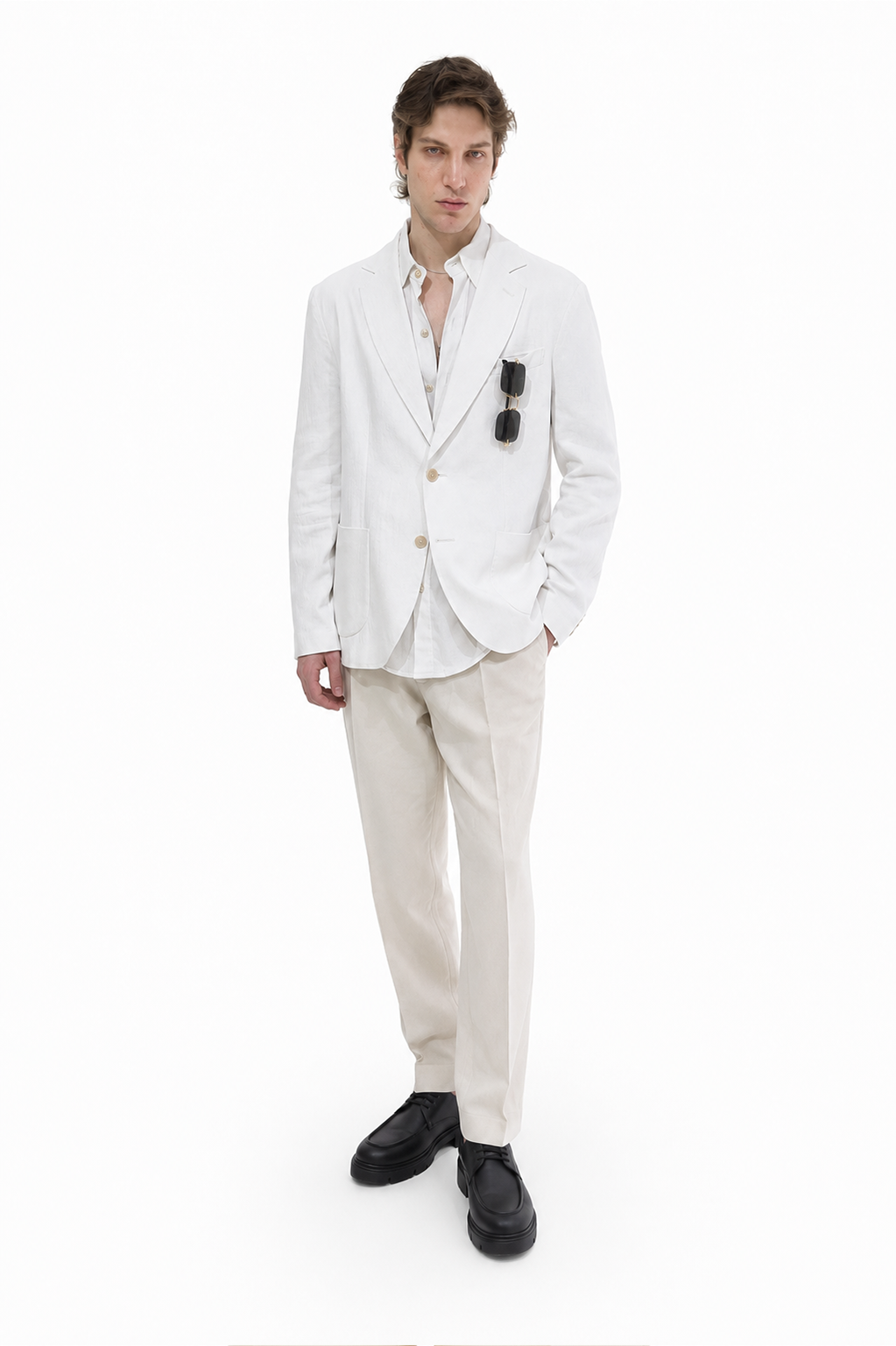 A lightweight white Patch-Pocket Linen Blazer featuring a two-button front, classic notch lapels, rounded patch pockets and a softly curved hem. The Marcell Linen Blazer combines breathable summer comfort with relaxed, contemporary tailoring.